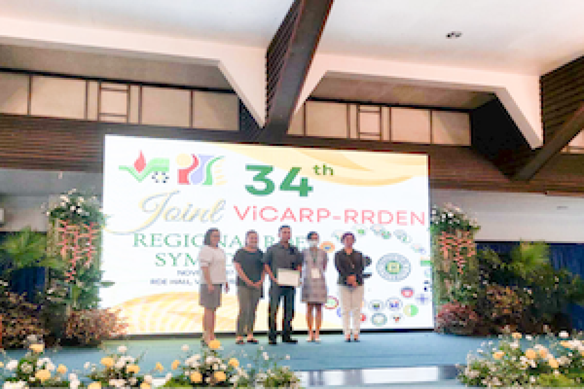 Awarding Ceremony for Outstanding RDE paper in the Development Category during the 34th Regional Research, Development, Extension and Innovation (RDEI) Symposium at the RDE Hall of the VSU in Baybay City, Leyte (Standing L-R: Dr. Ma. Juliet Ceniza, Ms. Divina Villaber, aProf. Marlon Tambis, Ms. Mary Rose Maniego, and Dr. Elvira Torres) (Image credit: Philrootcrops Facebook page)