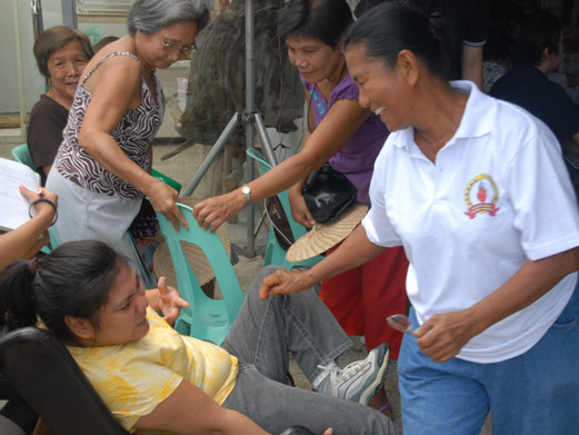 Mommy Edita (right, foreground) dotes on daughter Kate (left seated).