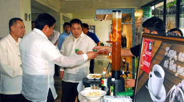 AGHAM Party-list representative Angelo B. Palmones (foreground), PCAARRD Deputy Executive Director for Aquatic Resources Cesario R. Pagdilao (extreme left), and BUTIL Party-list representative Agapito H. Guanlao try the free samples of” Flavors of Science”.