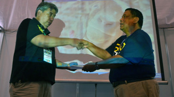 Book giving. Rene Almeda (left) of AGF receives a copy from Dr. Edwin C. Villar of PCAARRD.