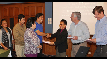 The ceremonial hand-over of the manuals to partner implementing agencies was led by PCAARRD Executive Director Patricio S. Faylon (fourth from left). Also in the event were (from left): Ms. Corazon Ignacio (representative PVO Pampanga), Dr. Eduardo Lapuz (chief, RADDL), Dr.Emelinda Lopez (chief, AHD, foreground), Dr. Voltaire Basinang (PVO Bulacan), Dr. Mike Nunn (ACIAR Programme Manager for Animal Health), and Dr. Patrick Blackall (project leader, Australia).  (Photo by Valerie M. Corales, S&T Media Service)