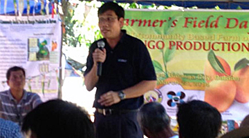 Dr. Melvin Carlos as he explains the importance of technology transfer in a community during the mango STCBF field day.